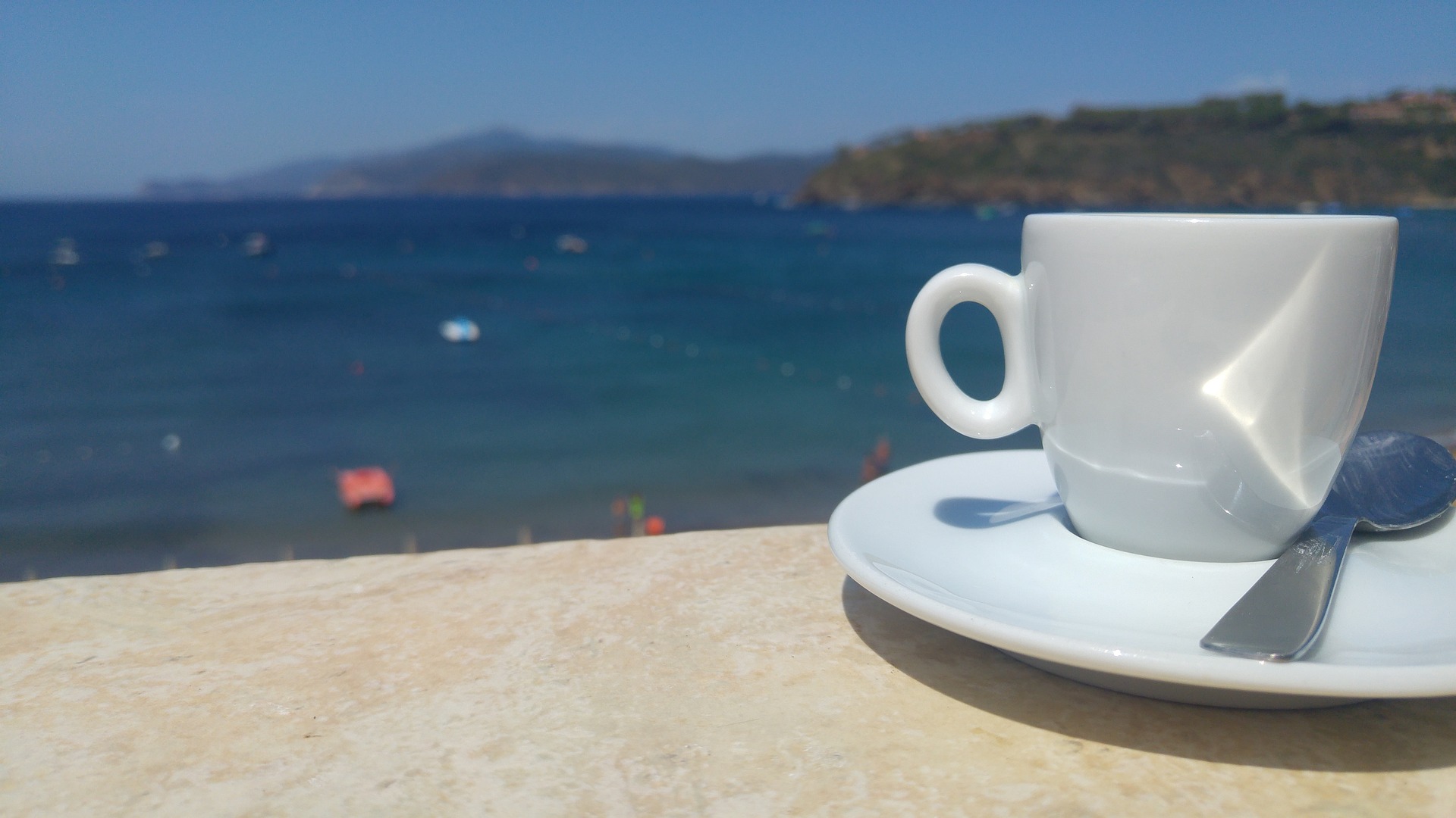 Empty espresso cup overlooking the sea