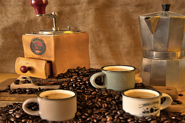 Vintage coffee grinder, moka pot and espresso cups